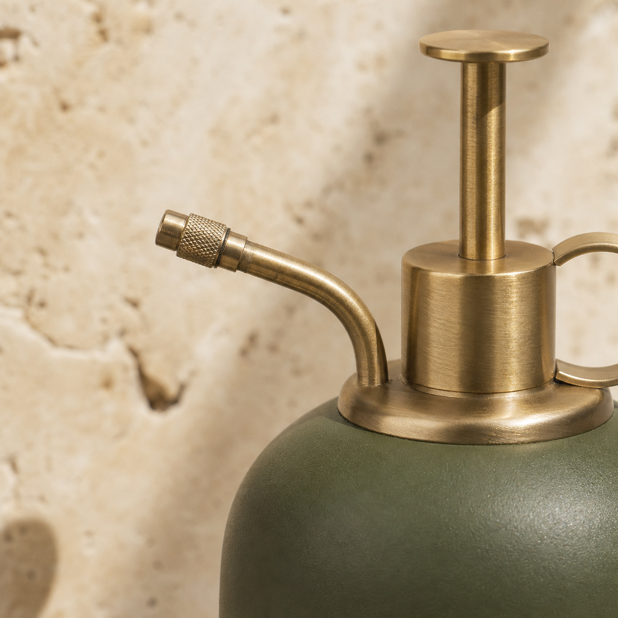 Brass-toned pump detail of the Moss Fine Mist Vessel